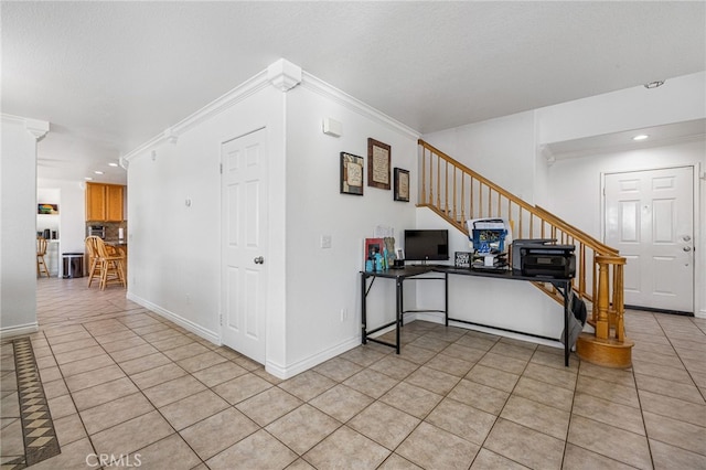 home office featuring crown molding and light tile patterned flooring