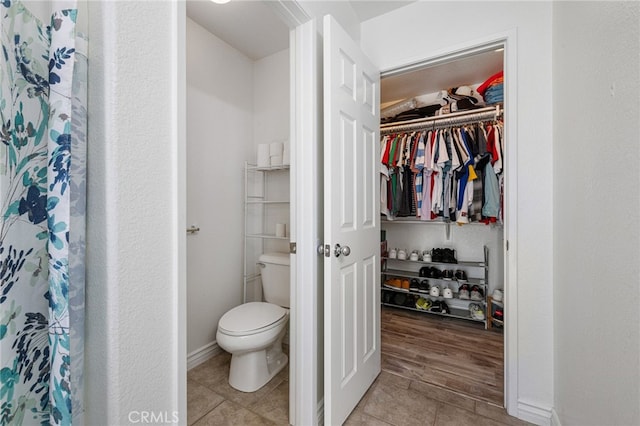 bathroom with toilet and tile patterned floors