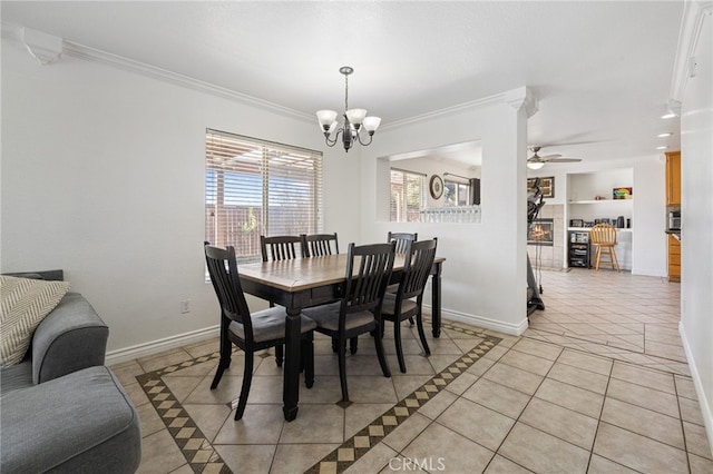 dining area featuring light tile patterned floors, built in features, ceiling fan with notable chandelier, and crown molding