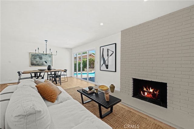 living room with a fireplace and wood-type flooring