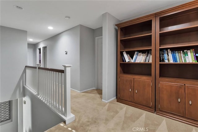 hallway with light colored carpet