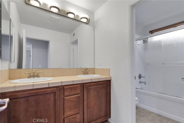 full bathroom with tile patterned flooring, shower / bathing tub combination, vanity, and toilet