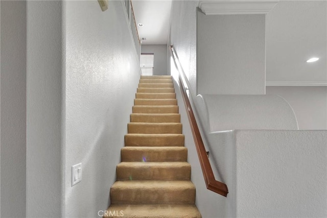 staircase featuring ornamental molding