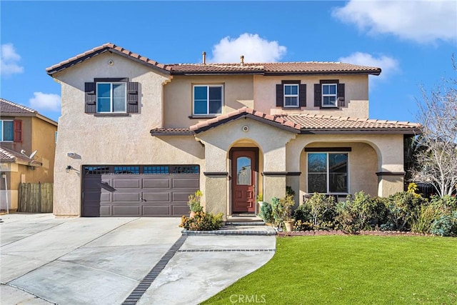 mediterranean / spanish house with a front lawn and a garage