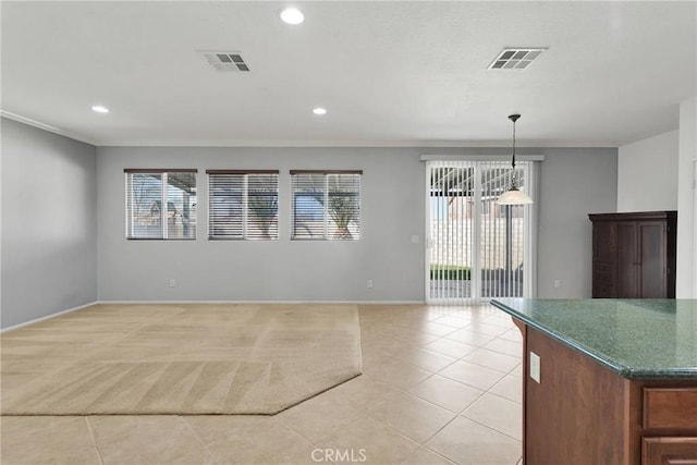 unfurnished dining area featuring light tile patterned floors and crown molding