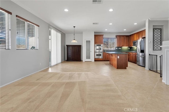 kitchen with pendant lighting, decorative backsplash, a kitchen island, appliances with stainless steel finishes, and light carpet