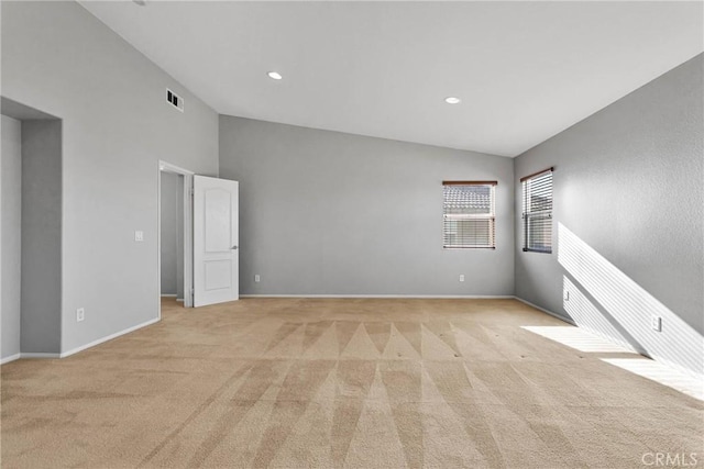 carpeted spare room with lofted ceiling