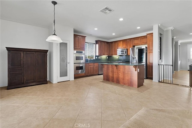 kitchen with a center island, tasteful backsplash, light tile patterned flooring, appliances with stainless steel finishes, and ornamental molding