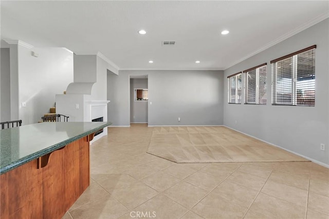 kitchen with light tile patterned flooring and crown molding