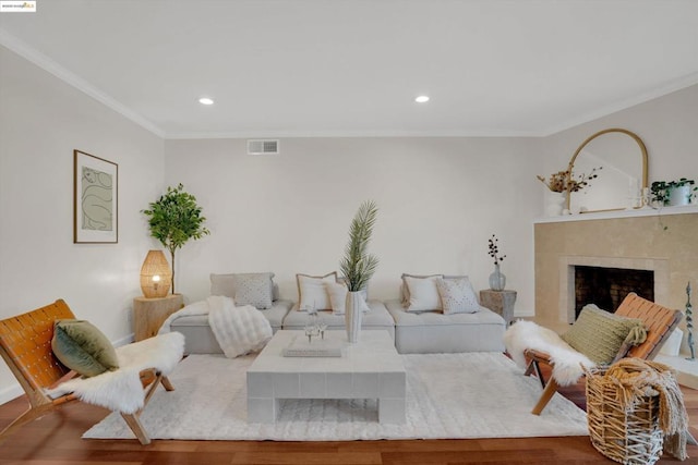 living room featuring wood-type flooring and crown molding