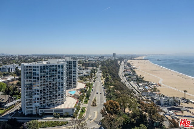 birds eye view of property featuring a beach view and a water view