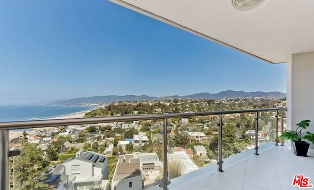 balcony featuring a water and mountain view