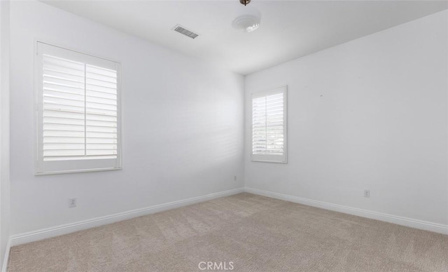 empty room featuring light carpet