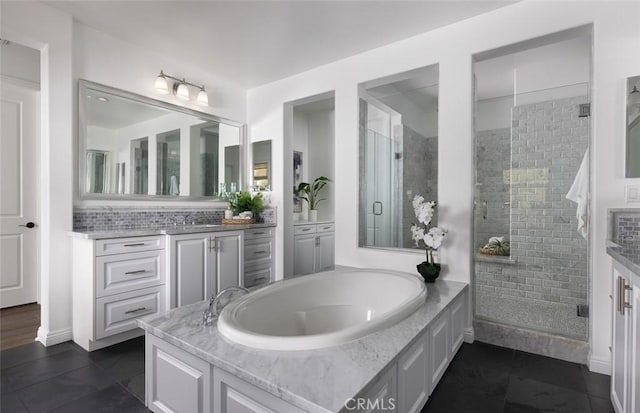 bathroom featuring plus walk in shower, tile patterned floors, and vanity