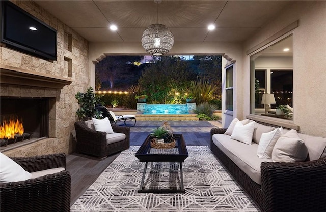 view of patio / terrace with an outdoor living space with a fireplace