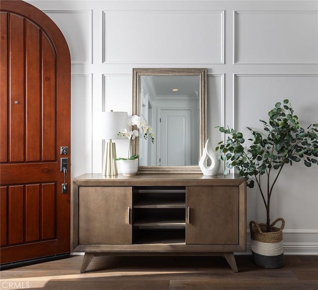 bar featuring hardwood / wood-style flooring and crown molding