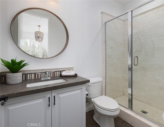 bathroom with walk in shower, tile patterned floors, vanity, and toilet