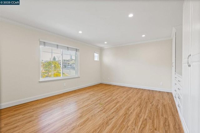 unfurnished room with light wood-type flooring and crown molding