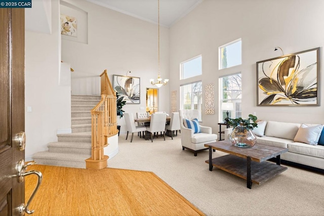 carpeted living room featuring a high ceiling and an inviting chandelier