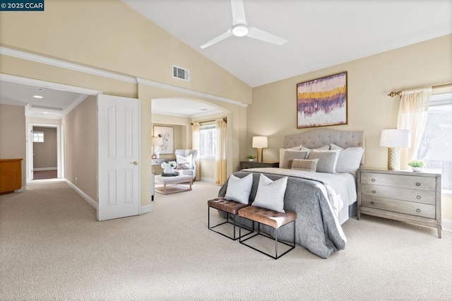 carpeted bedroom with vaulted ceiling, ornamental molding, and ceiling fan