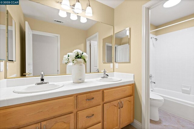 full bathroom with shower / tub combination, tile patterned floors, vanity, and toilet