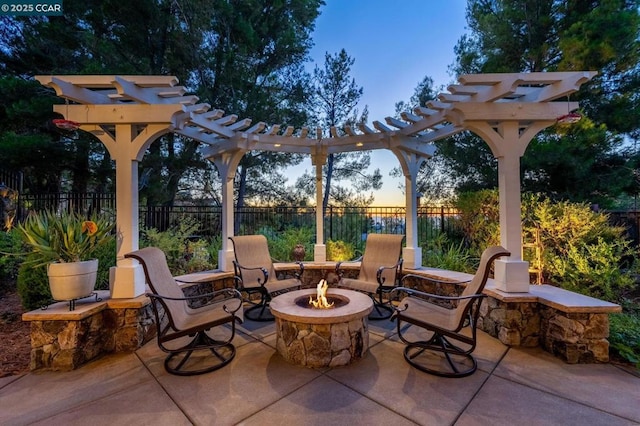 patio terrace at dusk with a pergola and a fire pit