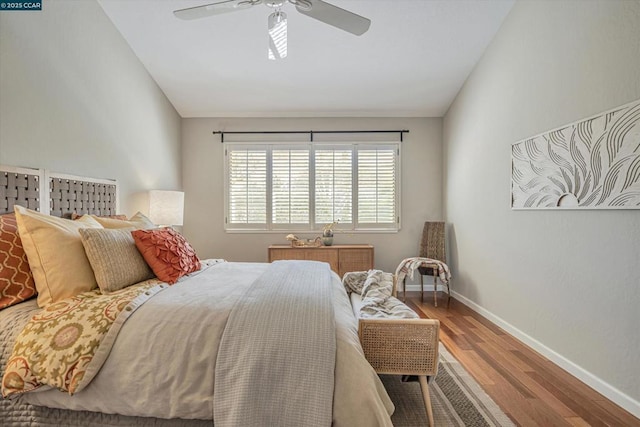 bedroom with lofted ceiling, ceiling fan, and wood-type flooring