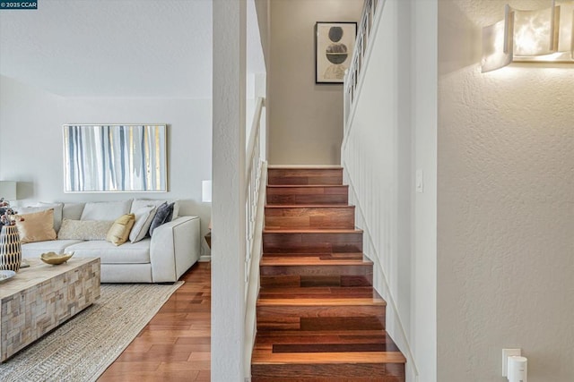 stairs with hardwood / wood-style floors