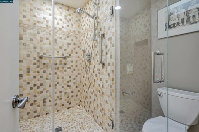 bathroom featuring toilet and an enclosed shower