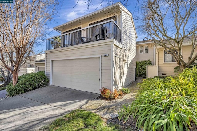 view of front of home with a balcony and a garage