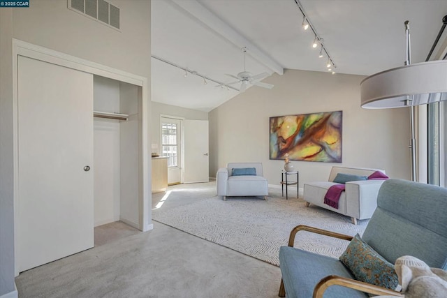 living area featuring ceiling fan and vaulted ceiling with beams