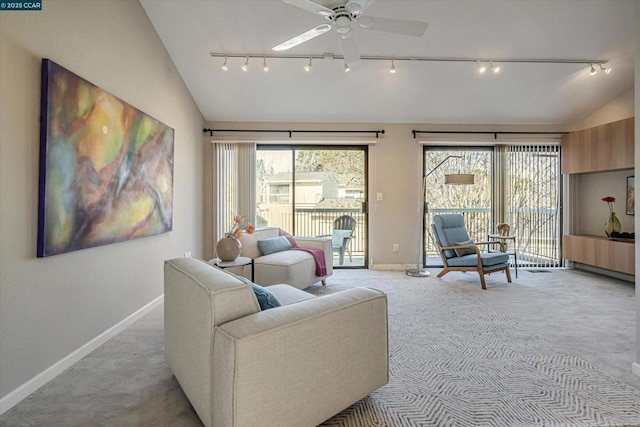 living room with ceiling fan, light colored carpet, lofted ceiling, and plenty of natural light