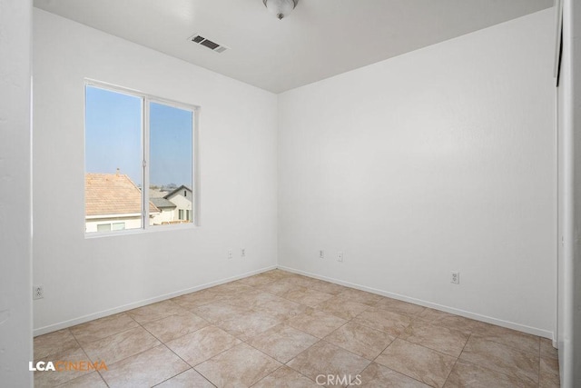 spare room featuring light tile patterned floors