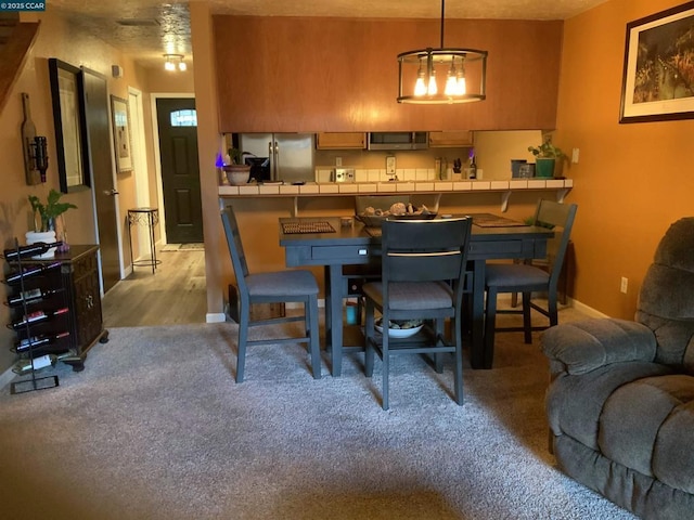 dining area with light colored carpet