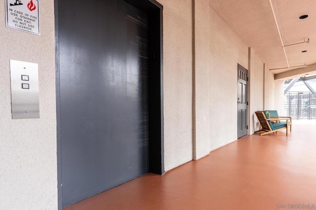 interior space with elevator and concrete flooring