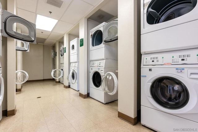 clothes washing area with washer and dryer and stacked washer / drying machine