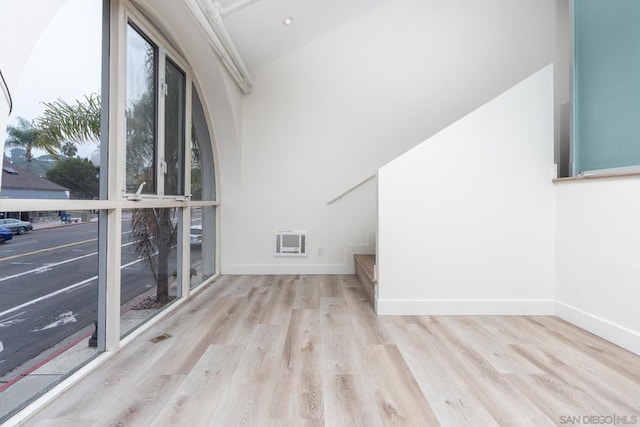 interior space with lofted ceiling and light hardwood / wood-style floors