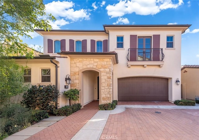 view of front of house with a garage and a balcony