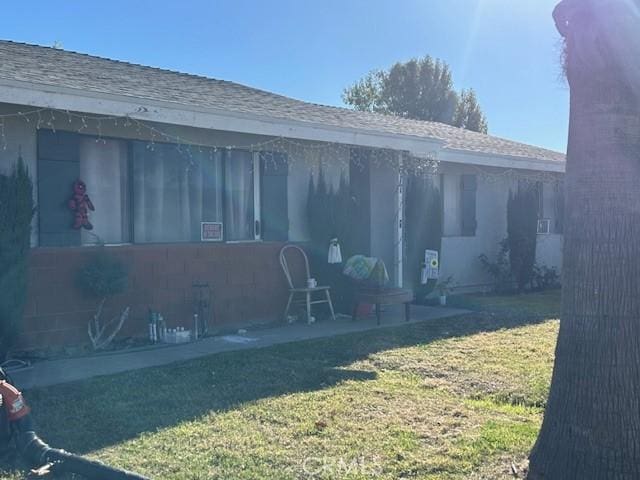 rear view of property with a lawn