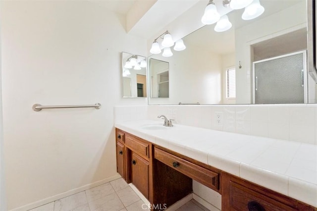 bathroom featuring a shower with door, tile patterned floors, and vanity