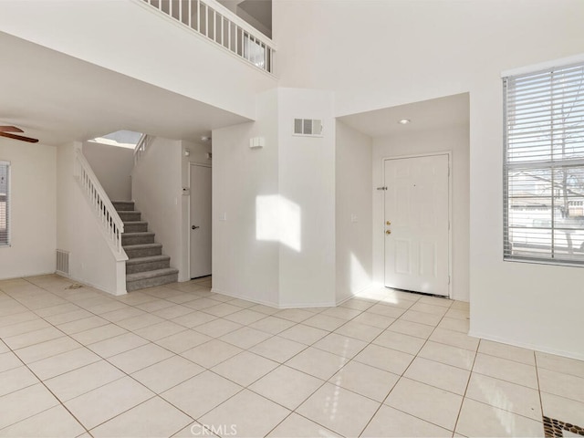 entryway featuring ceiling fan and light tile patterned flooring