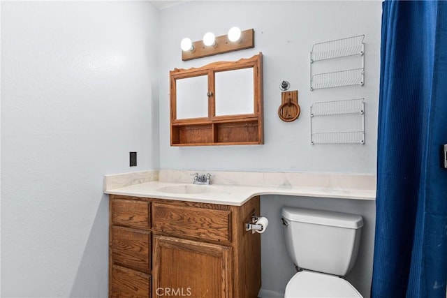 bathroom with toilet and vanity