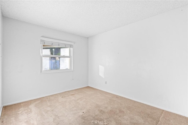 carpeted spare room with a textured ceiling