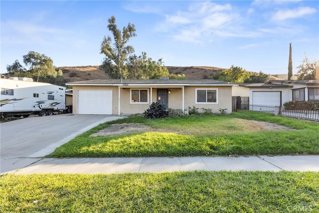 single story home featuring a front yard and a garage