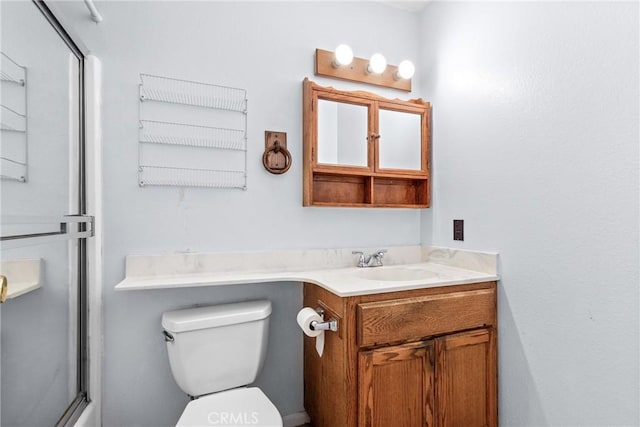 bathroom with toilet, an enclosed shower, and vanity