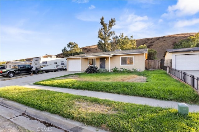 ranch-style house with a front yard and a garage