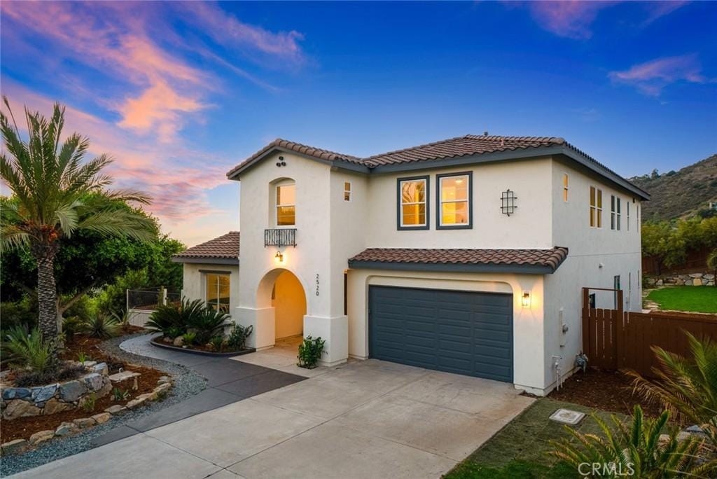 mediterranean / spanish-style house with a garage