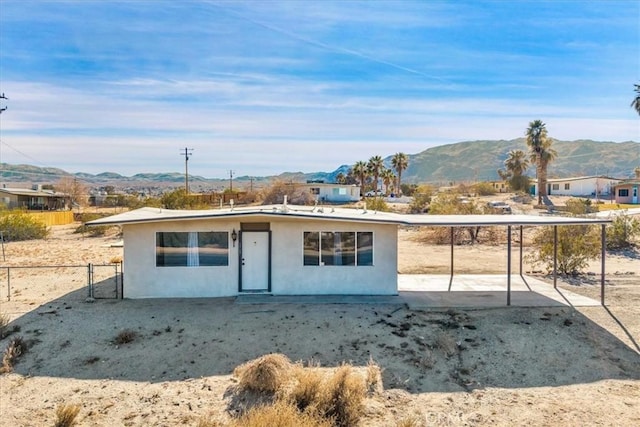 rear view of house featuring a mountain view