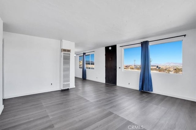 empty room with dark hardwood / wood-style floors