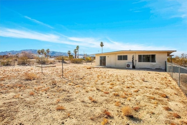 back of house featuring ac unit and a mountain view